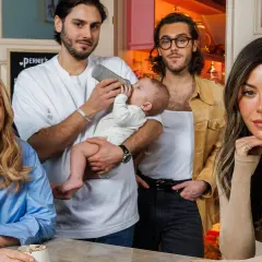 Familjen samlad: en kvinna ler, en man matar ett barn, en annan man står bredvid. Kanske en framtida bild av Benjamin Ingrosso barn.