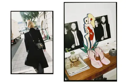 En kvinna i svart rock går på trottoaren i Stockholm. Bredvid syns en hylla med foton, en konstnärlig figur och rosa klackskor från Teurn Studios.