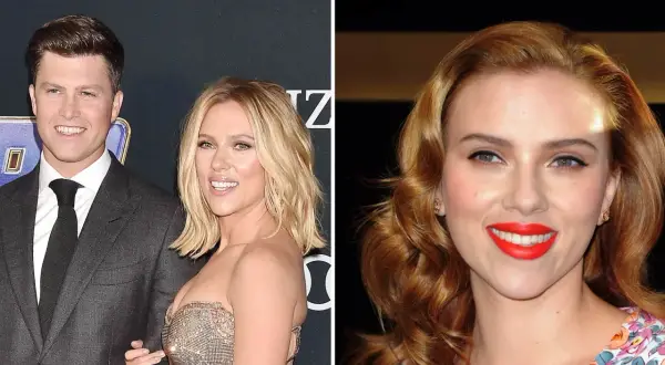 Scarlett Johansson and Colin Jost smiling on a red carpet.