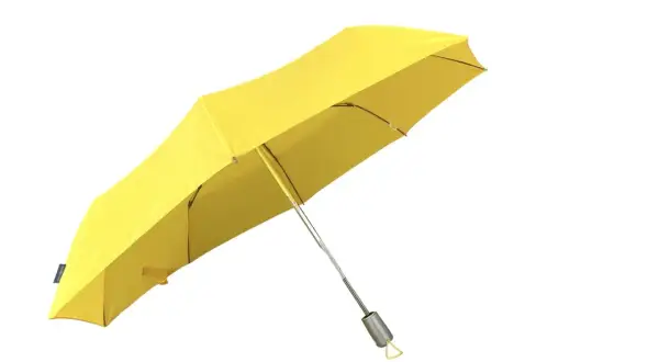 Ett gult paraply, redo att skydda mot regn. Fina paraplyer som dessa lyser upp en grå dag.