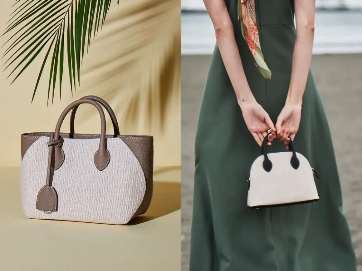 Två eleganta handväskor, en beige och brun tygväska med läderdetaljer, och en mindre vit kupolformad väska med svarta detaljer, som en baron necessär.