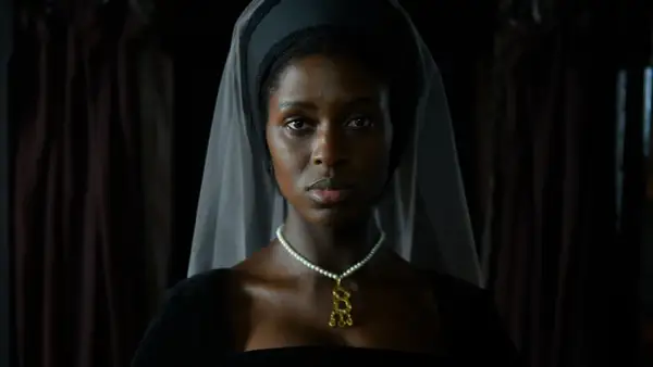 En kvinna i historisk dräkt, med slöja och pärlhalsband, i en scen från anne boleyn series.